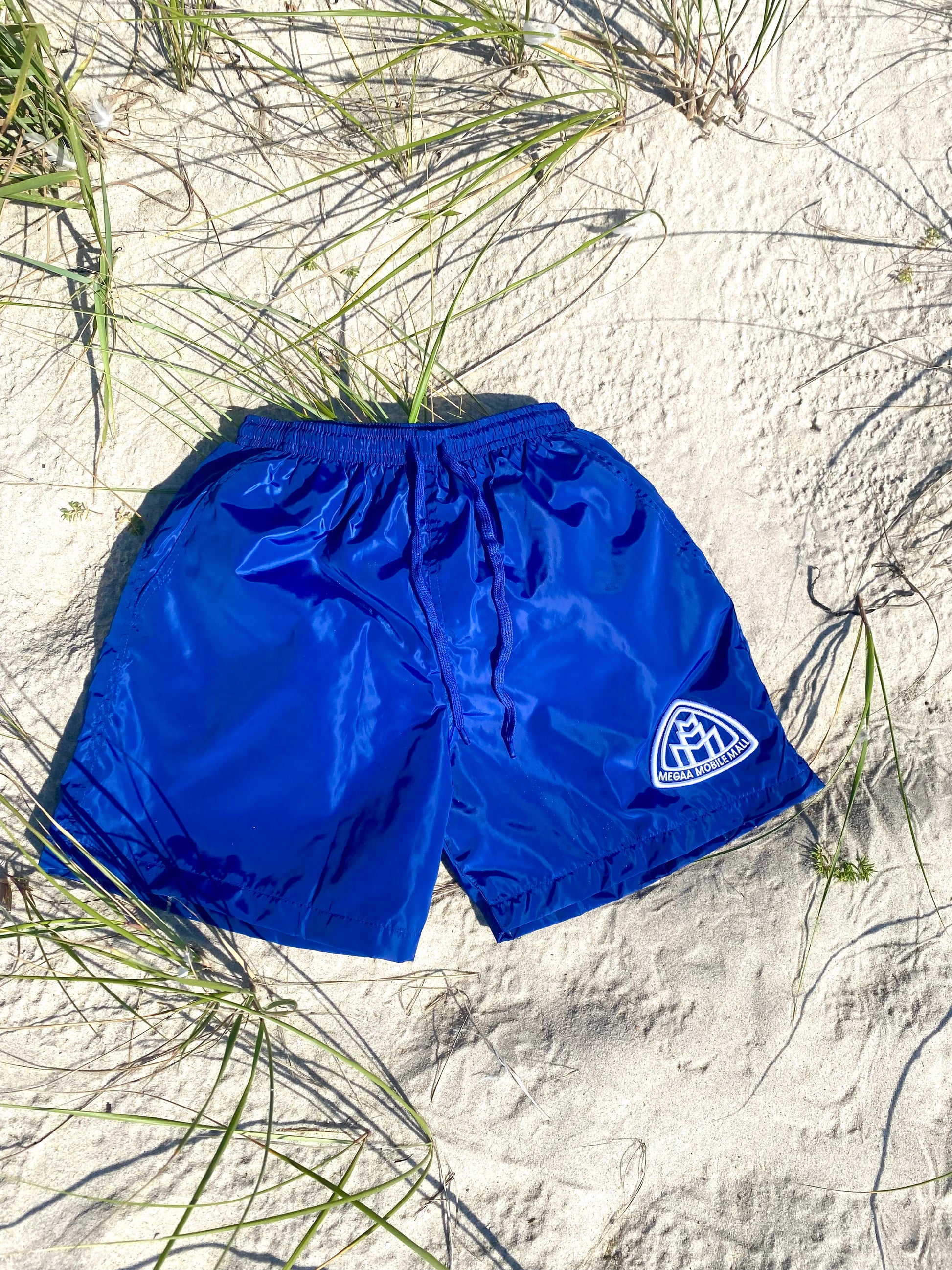 Blue Triple M Swim Trunks sand on the beach 